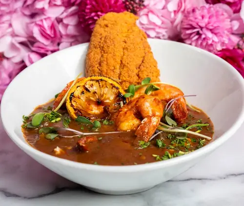 Fried catfish and shrimp in a rich gravy bowl