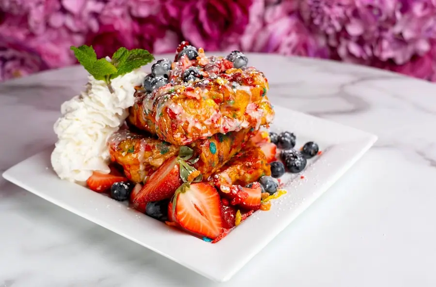 Fruity Pebbles French toast with berries and whipped cream